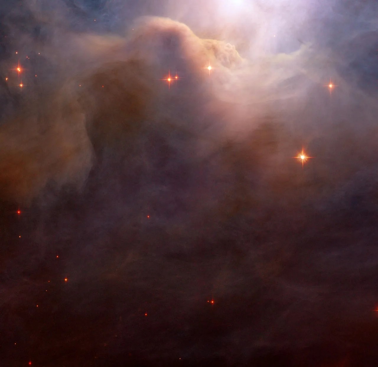 Large cloud of dark purple dust and gas with a few orange stars peppered throughout.