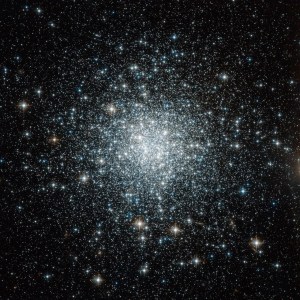 This is a globular cluster, a sphere of tens of thousands of stars. Most of them are a whitish color, and more concentrated in the center of the sphere. As you move farther from the center, there are fewer stars.