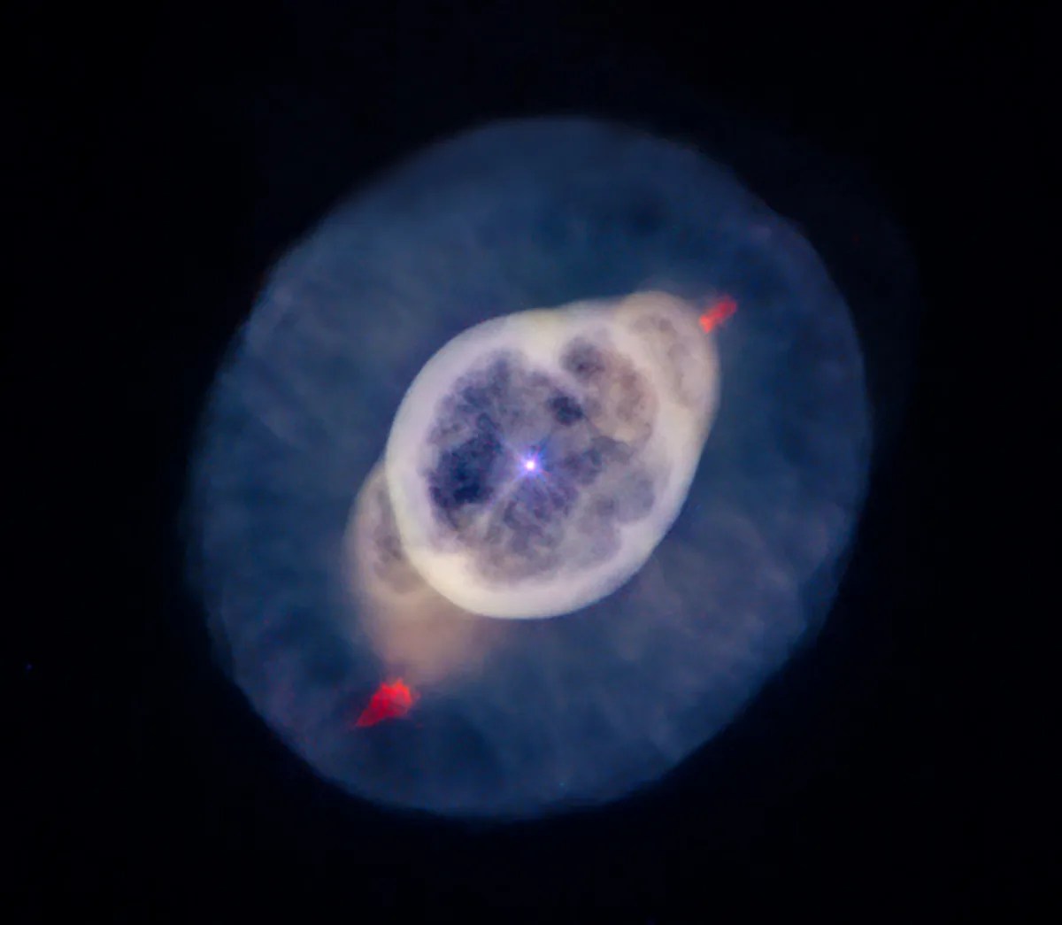 A blue star shining at the center of the nebula is surrounded by a thick white bubble, which turns pale orange at the outer edges. It has a small red "flare" outside this bubble at either pole, and a thick spherical layer of blue around the whole structure.