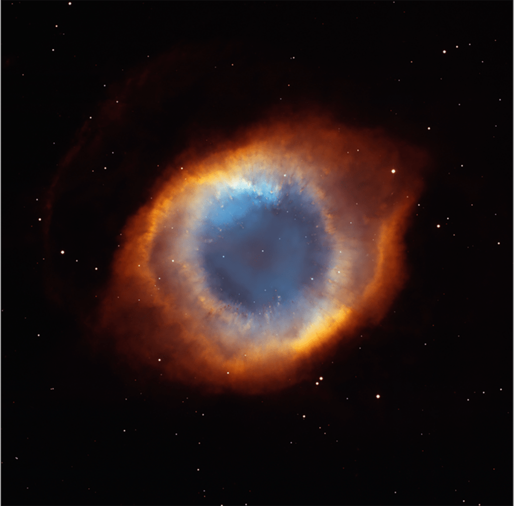 This nebula resembles an eye, with the "pupil" immediately around the star appearing a light blue, the "iris" fading into a mixture of blue, orange, and red with a yellow-orange ring around it, and the sclera appearing bright red-orange.