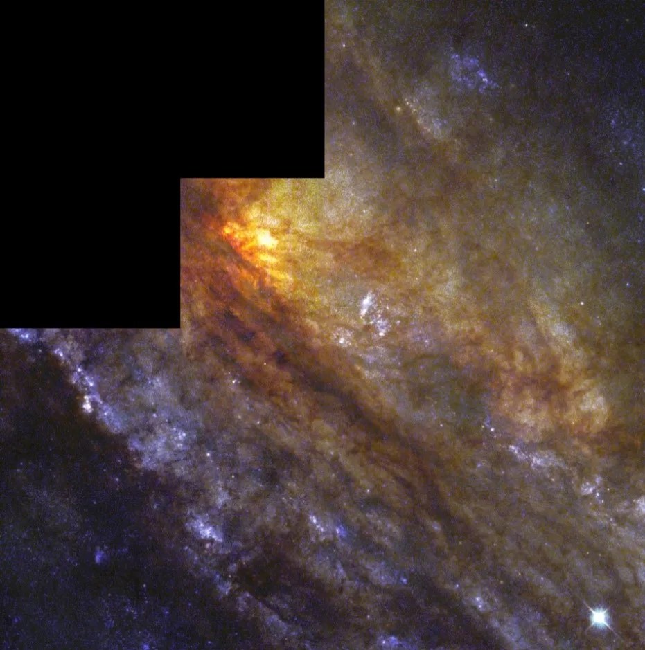 The center of this giant spiral galaxy appears yellow, and is surrounded by a reddish-brown cloud of gas and dust. Arms farther from the center are a purplish-blue, dotted with dark clouds of gas.
