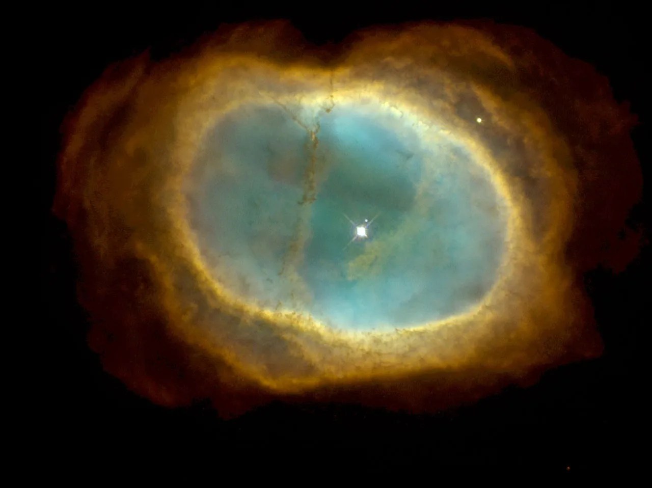 A bright star shines at the center of a rainbow-colored "bubble" spreading outward from it. The inner oval around the star is a turquoise color, which has a yellow ring around it, which then turns to orange, and has red wisps at the outer edges.