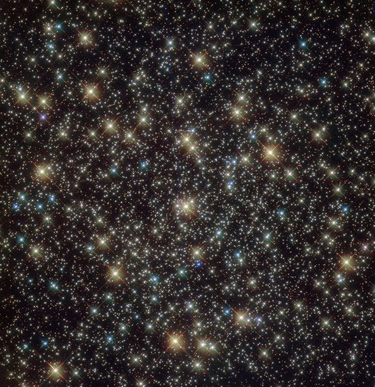 A field of large bright yellow stars and smaller blue and white stars.