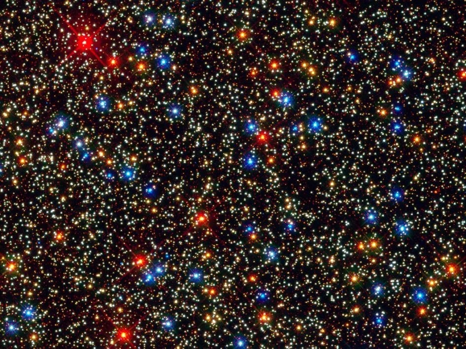 A field of stars in colors of red, blue, yellow, white, and orange.