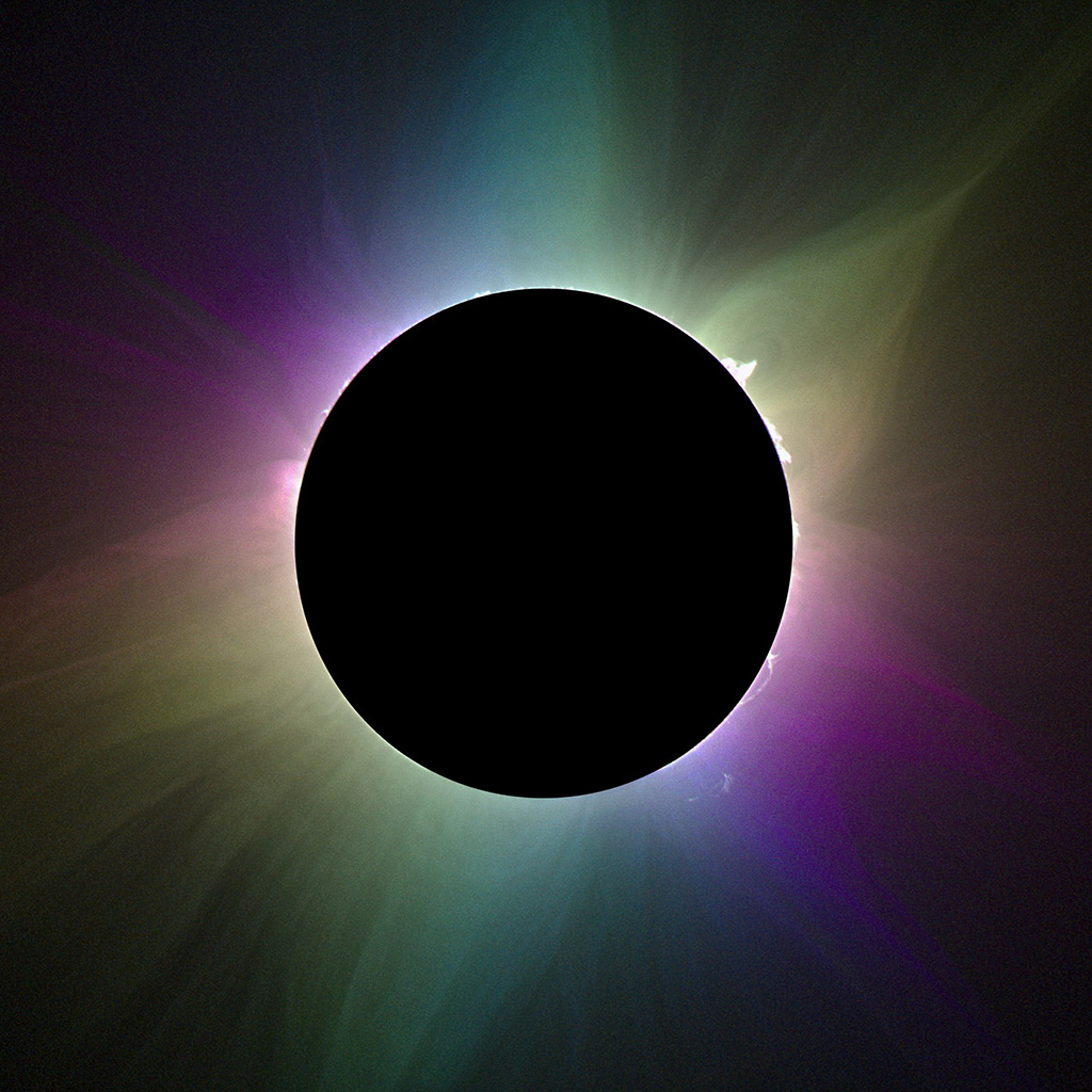 A black sphere eclipses the sun and colorful rays of light emanate from behind.
