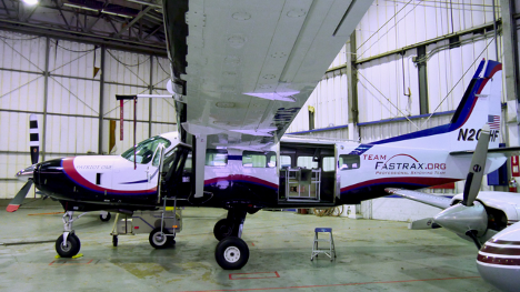 Photo of small airplane being loaded with the CubeSat