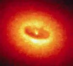 A disk in orange-red, and yellow-white. A yellow white point at image center surrounded by a deep orange-red disk that is ringed by yellow-white and then more orange-red.
