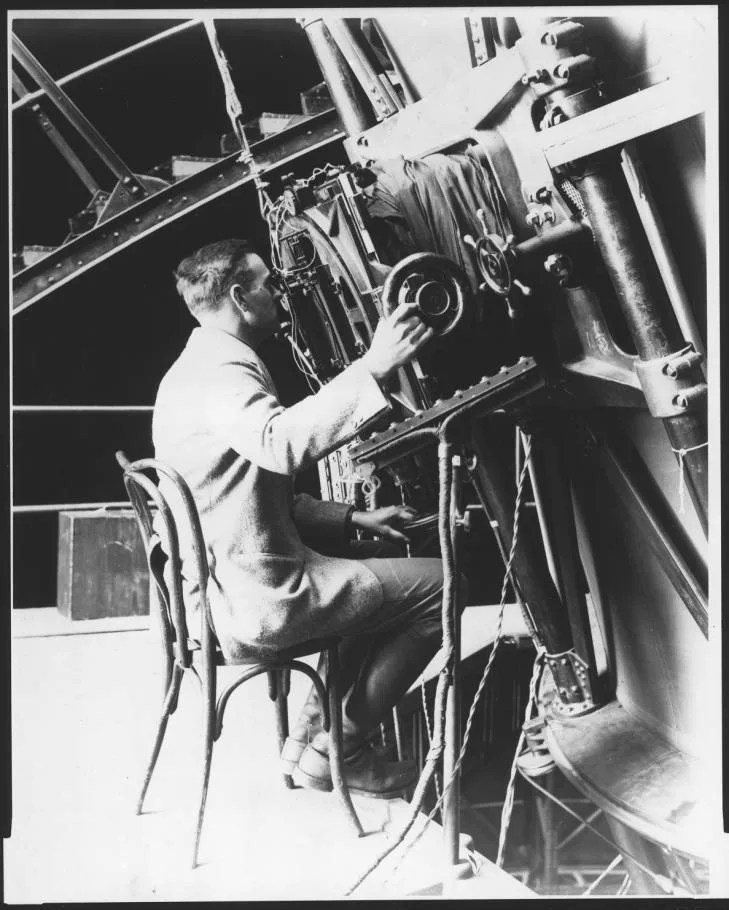 Edwin Hubble looking through 100-inch telescope at Mount Wilson Observatory
