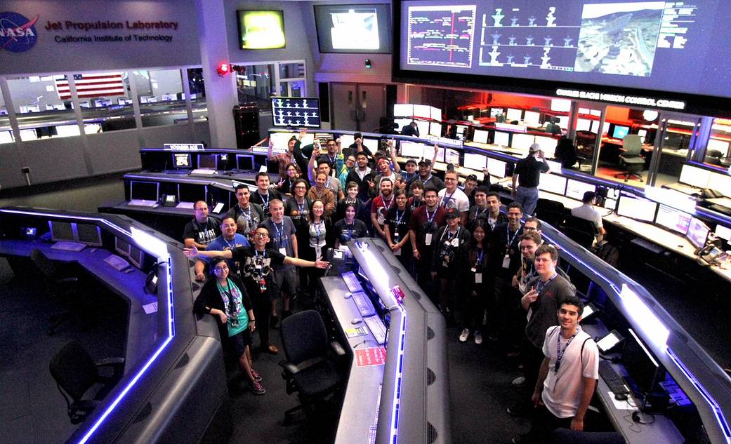 Group of students assembled in a spacious control center.