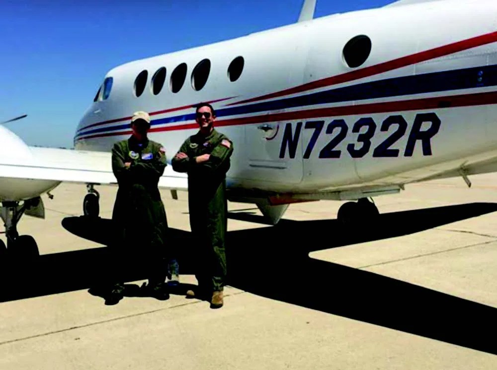 Photo of B200 aircraft and pilots