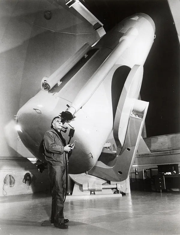 Edwin Hubble at the eyepiece of a telescope