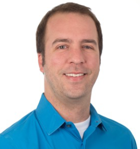 Portrait photo of a smiling man with short brown hair wearing a bright blue button down shirt