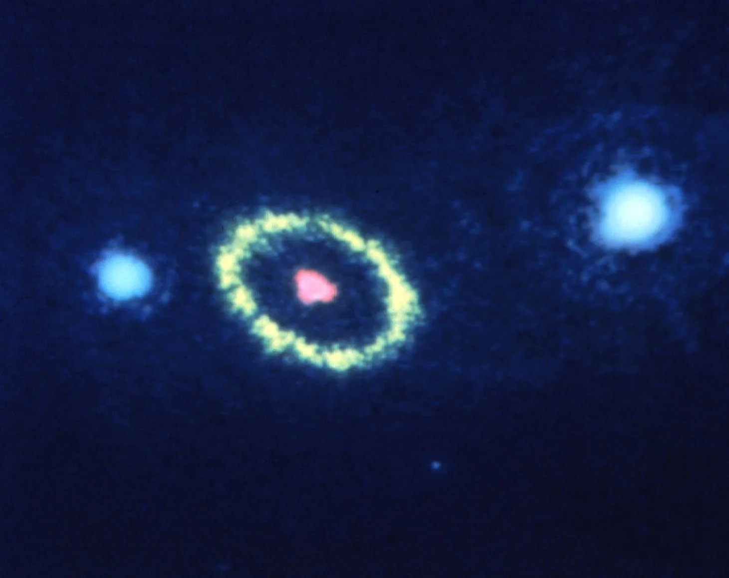 three bright spots and a ring in space