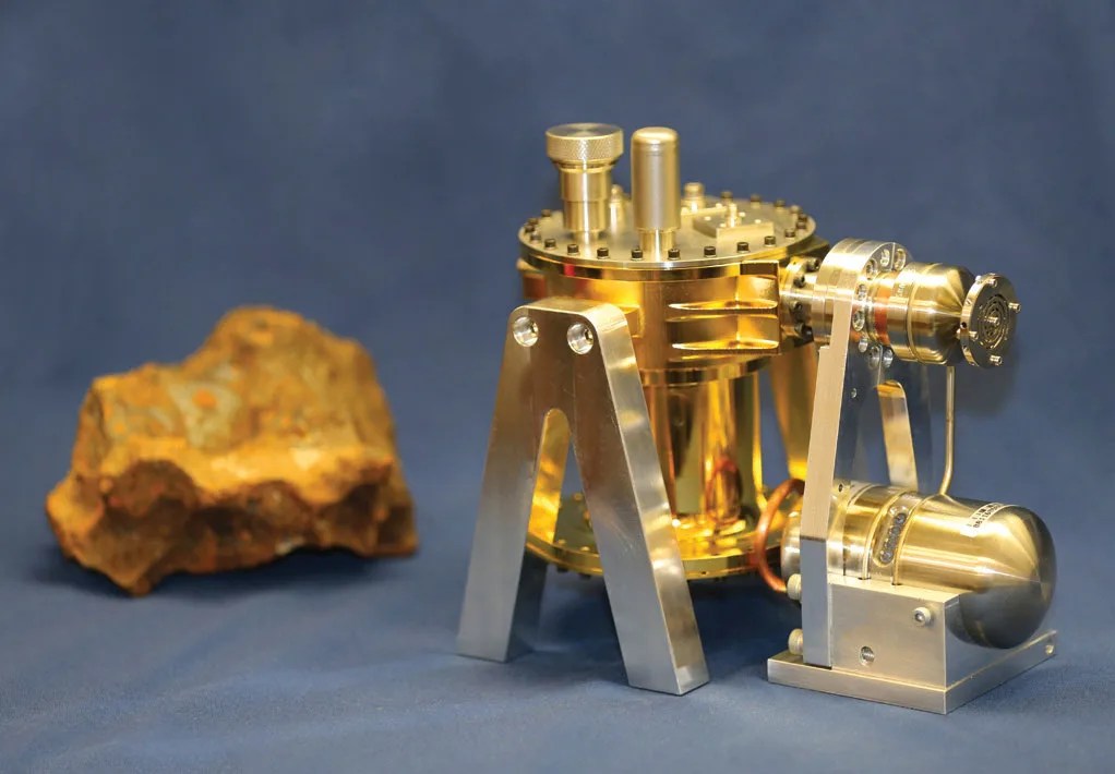 Photo of the GeMini Plus gamma-ray detector, a gold cylinder