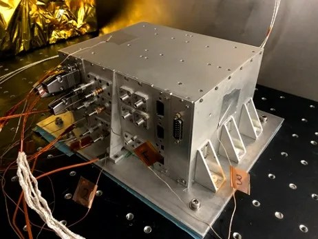 Photograph of silver colored metal hardware box with several colored wires plugged into it