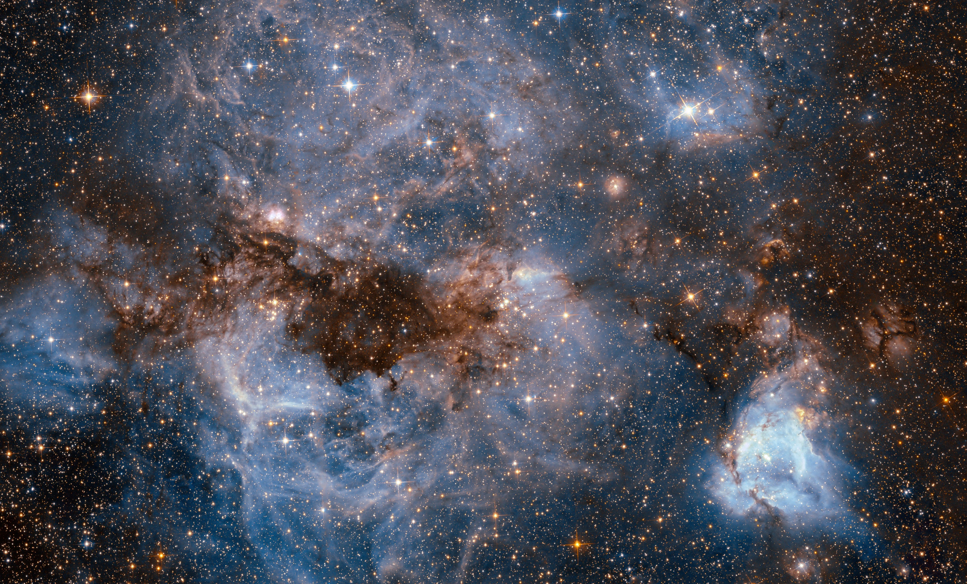 This shot from the nasa/esa hubble space telescope shows a maelstrom of glowing gas and dark dust within one of the milky way’s satellite galaxies, the large magellanic cloud (lmc).