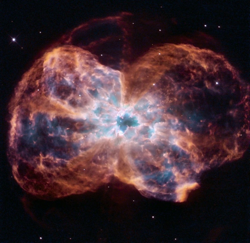 Red/orange bubbles of gas explde from a bluish center against black