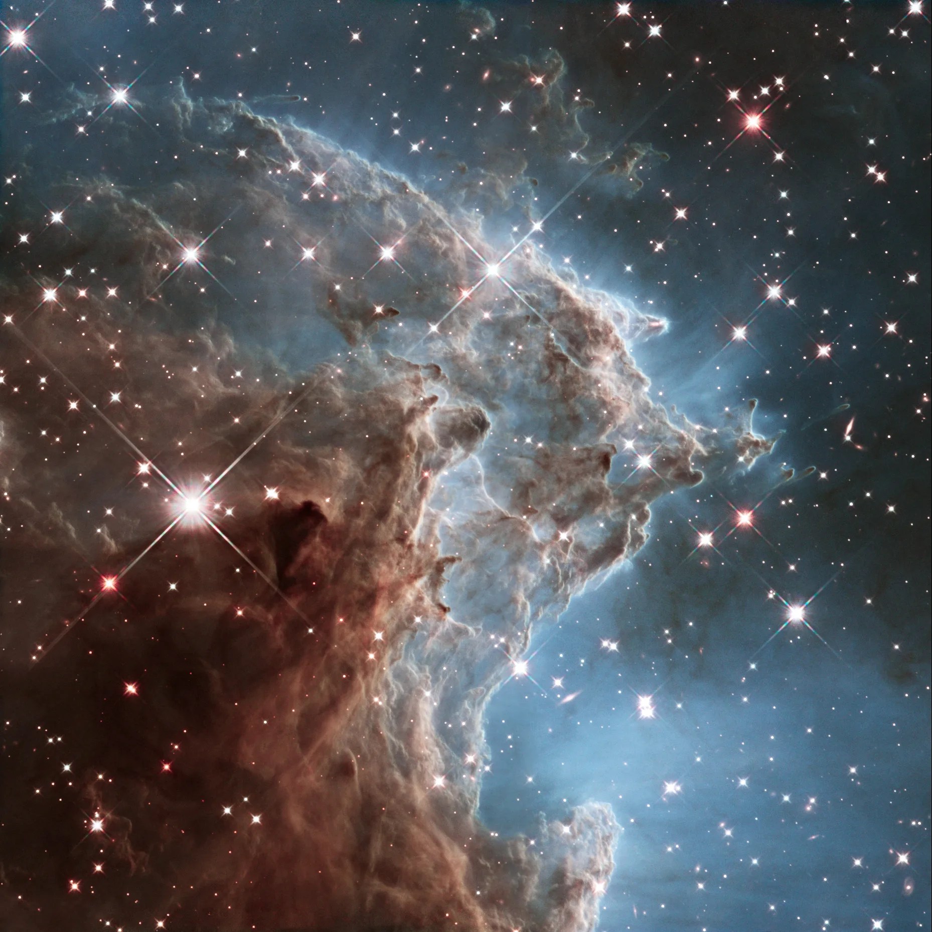 This colorful hubble space telescope mosaic of a small portion of the monkey head nebula unveils a collection of carved knots of