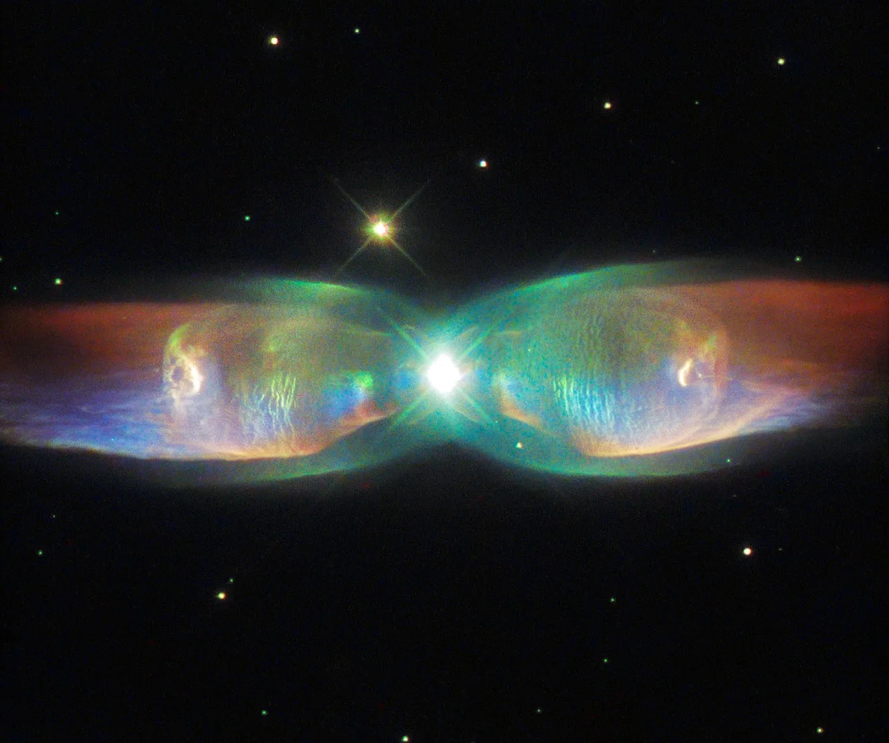 The shimmering colors visible in this NASA/ESA Hubble Space Telescope image show off the complexity of the Twin Jet Nebula.