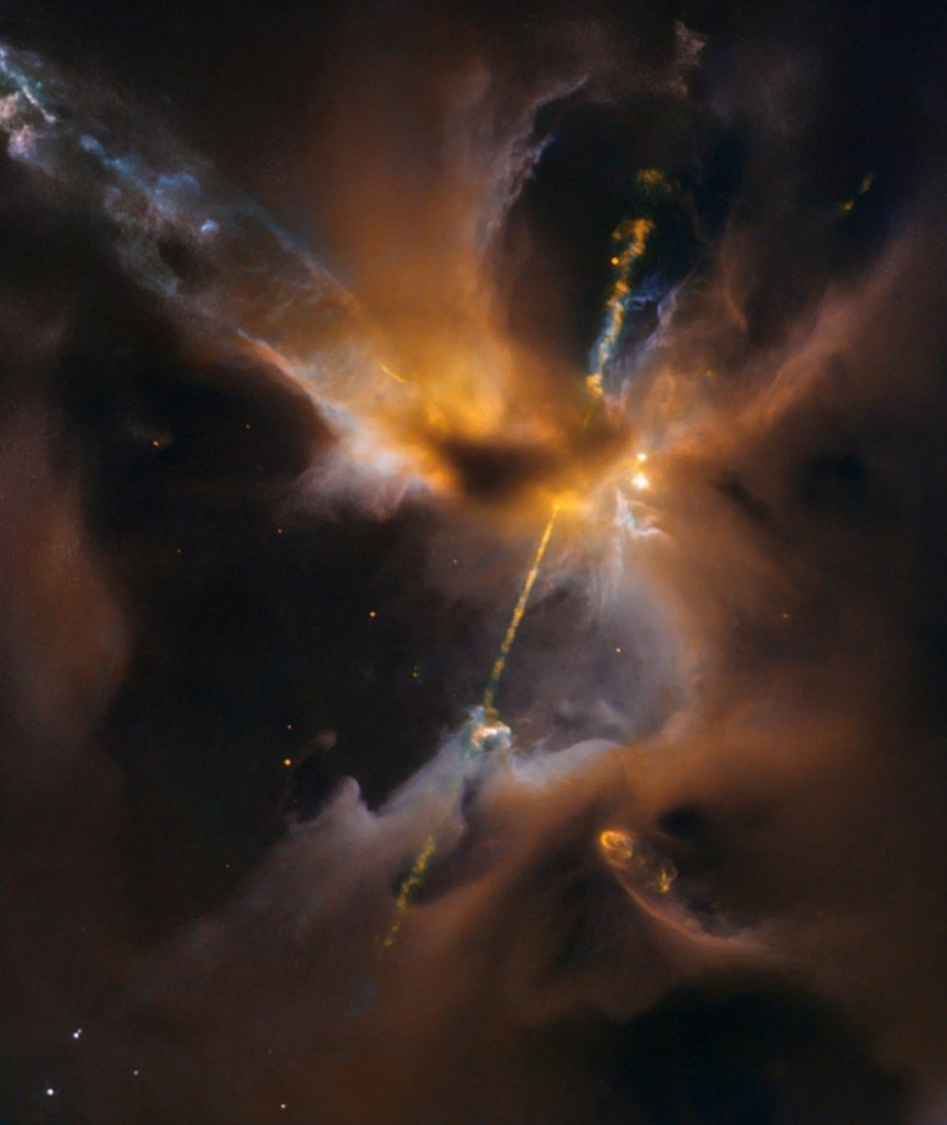 rusty yellow clouds and dark brown clouds fill the scene. A bright jet stretches from lower left to upper right.