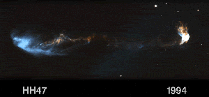 Glowing, clumpy streams of material moving left and right. Left side of the image is a bright-blue cloud slowly moving further to the left. Extending from the blue cloud is a tenuous strand of material moving toward the right. It appears to connect to a bright-white cloud at far right. This white cloud is also moving further to the right