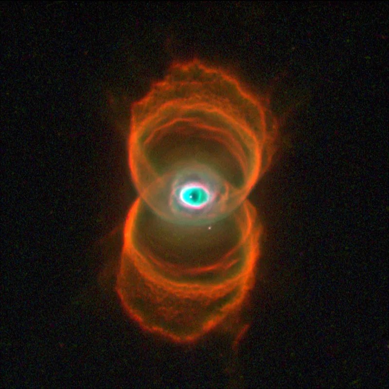 Multiple orange rings of light form a figure eight around an eye-shaped greenish center.