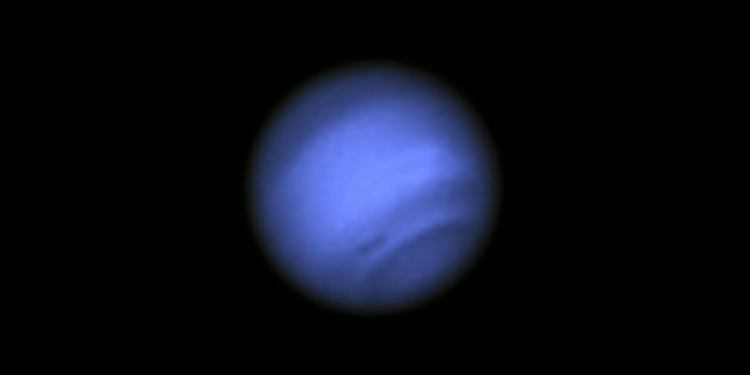 A hazy, dark blue sphere against black space.
