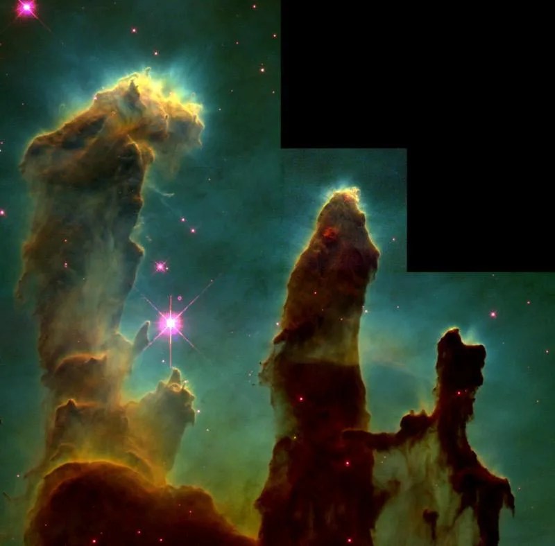 Three dark brown pillars of dust and gas jut out against a greenish background.