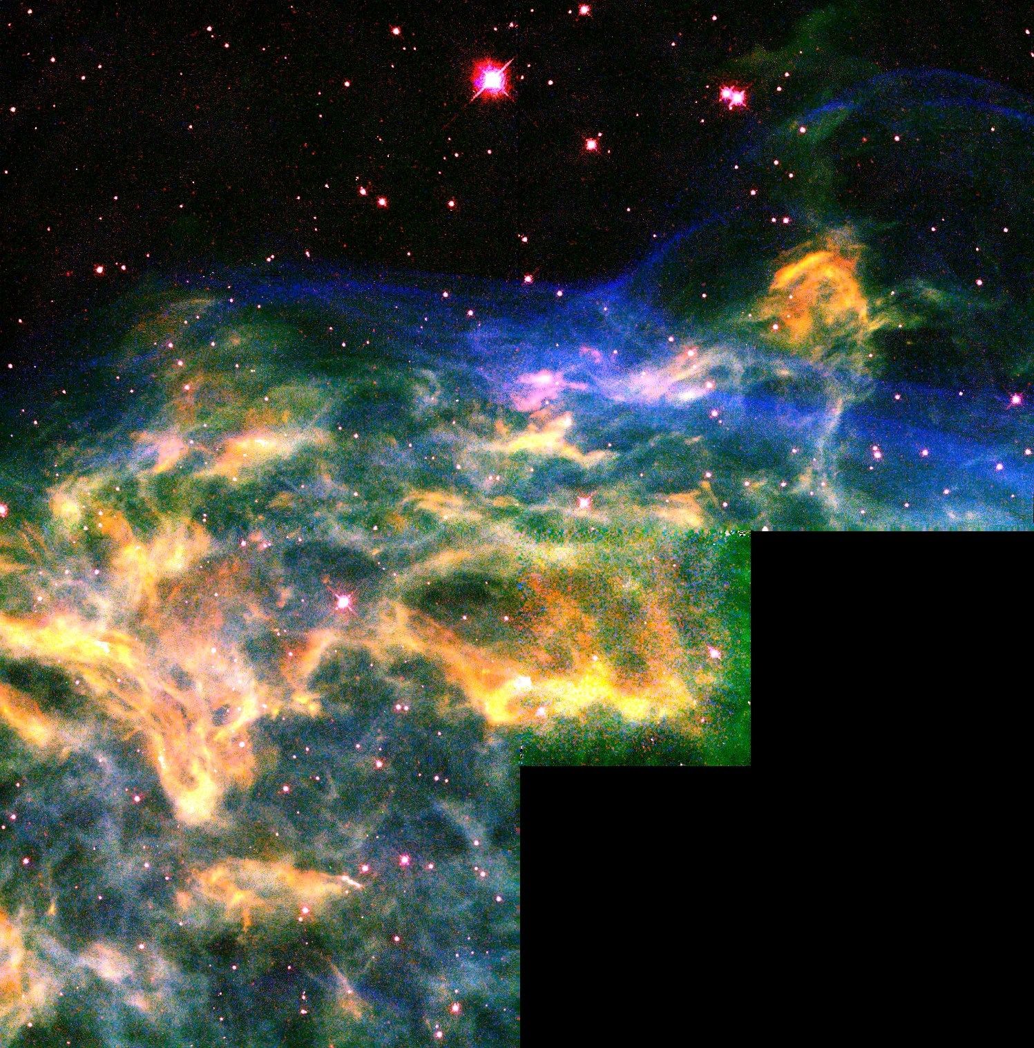 colorful streams of yellow, blue, and green gas and dust extend from the lower left to the center right.