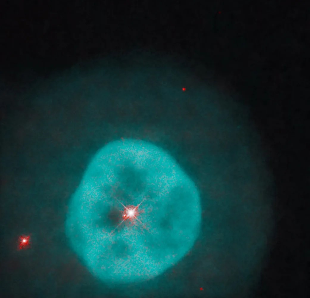Hubble image of a spherical, turquoise nebula with a bright central star.