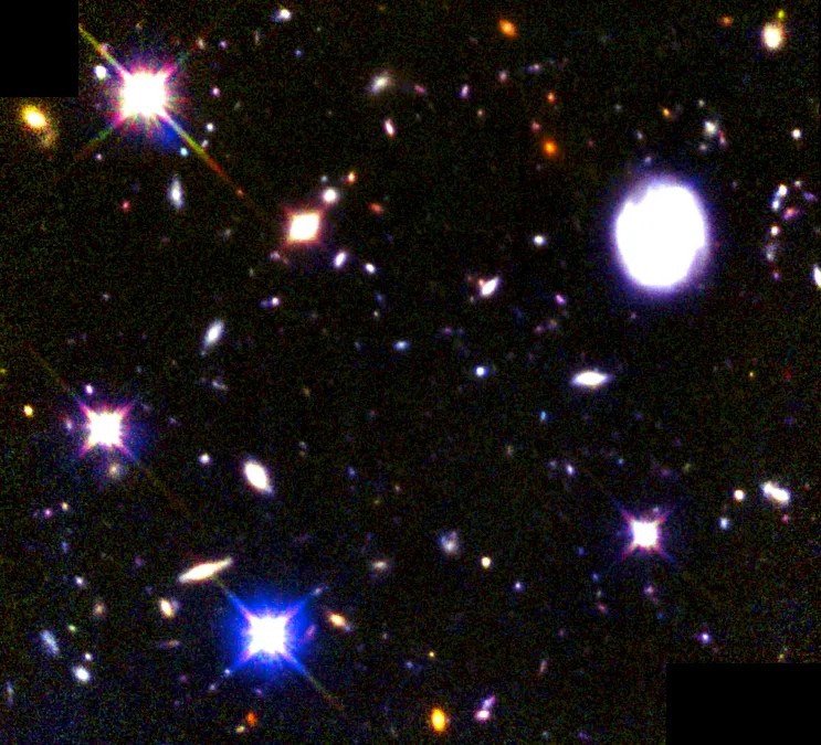 The field is dotted with galaxies of various sizes, shapes, and colors