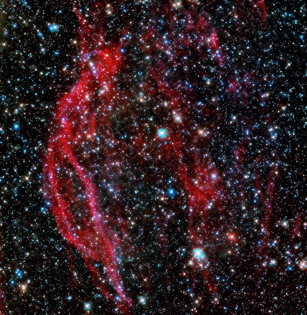 Hubble space telescope images the glowing red tendrils of gas from the supernova remnant, dem l249.