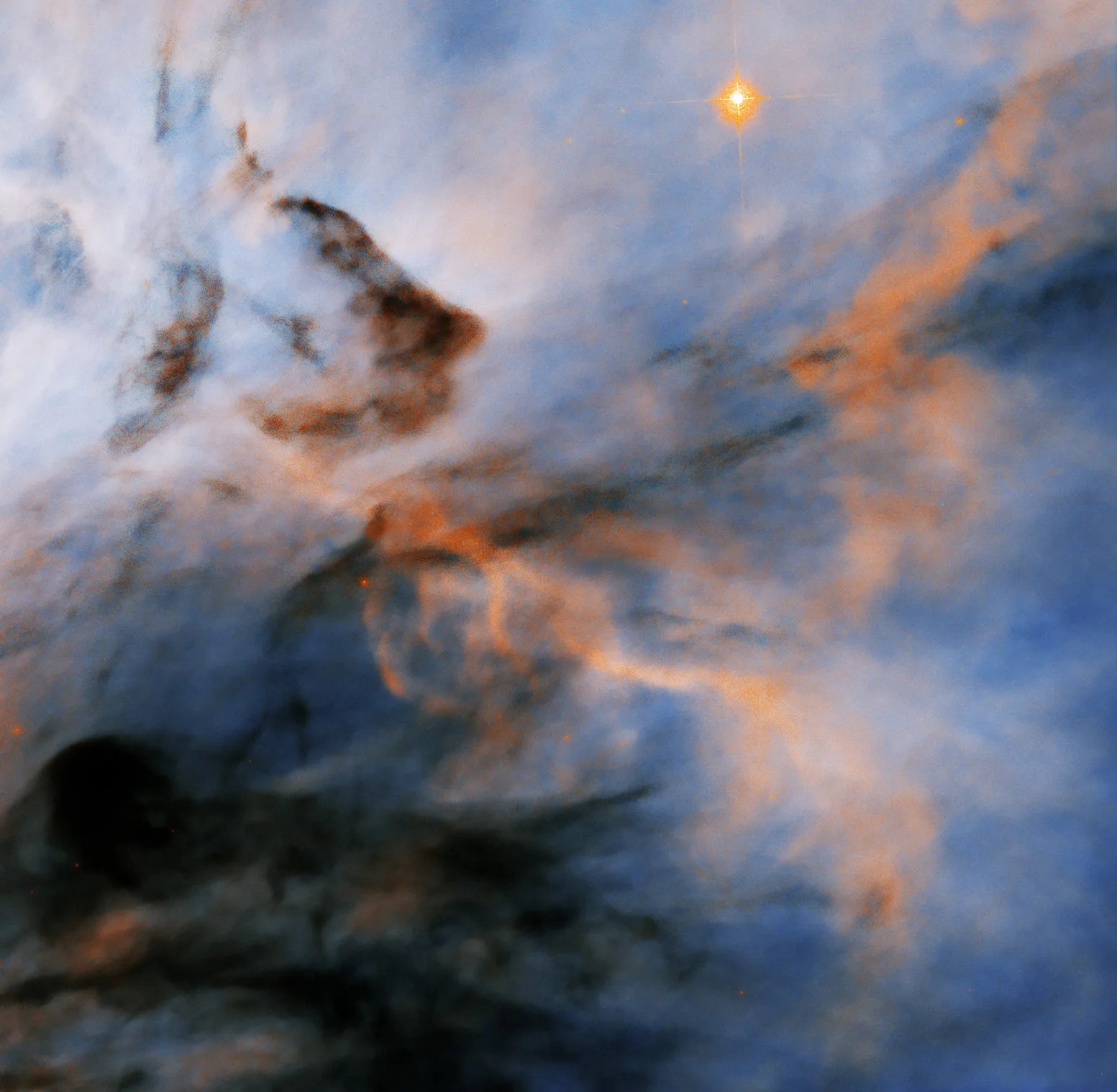 Hubble image of blue and white background cloud superimposed with orange and dark cloudy wisps