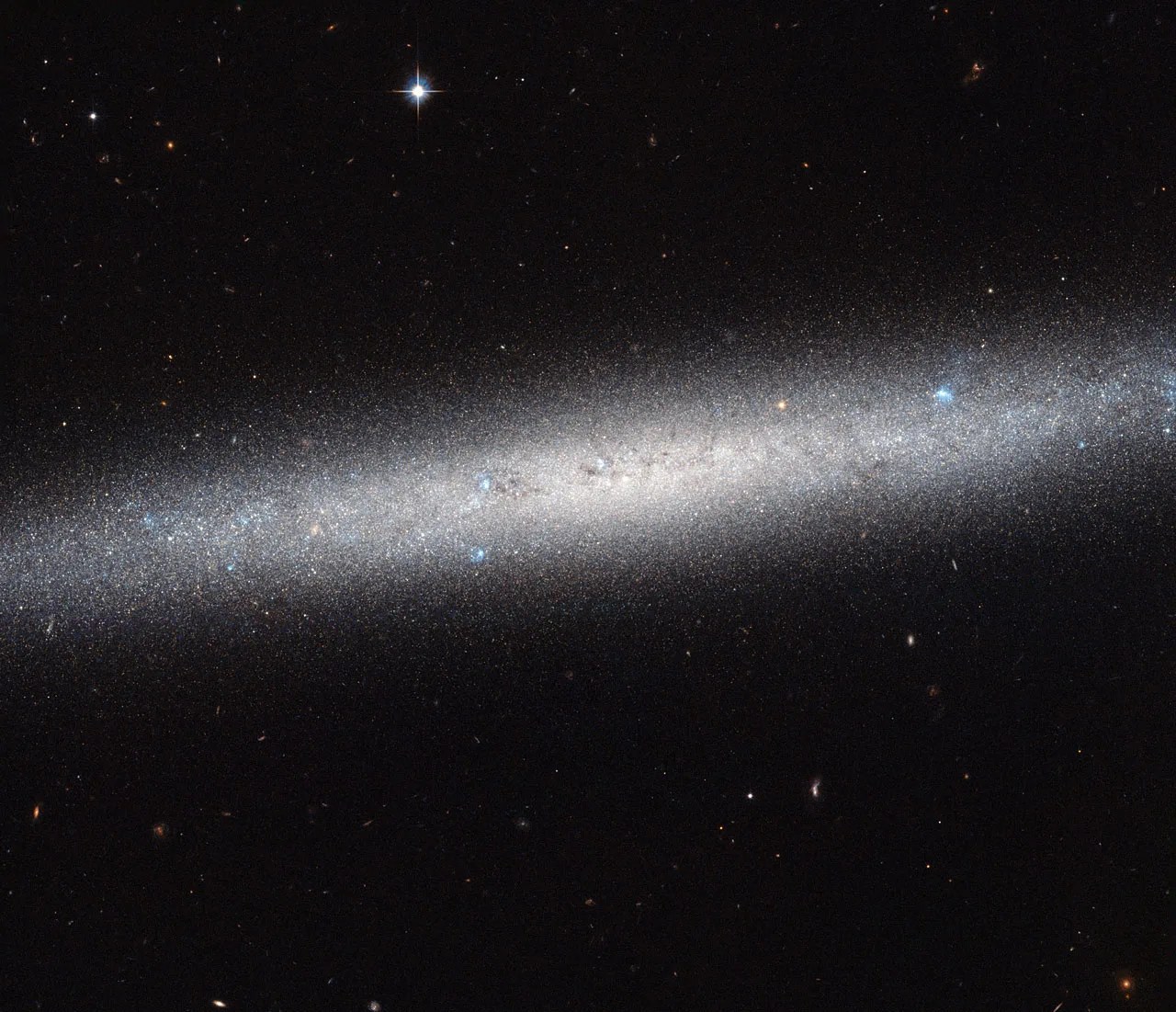 An elliptical formation of stars on a black background