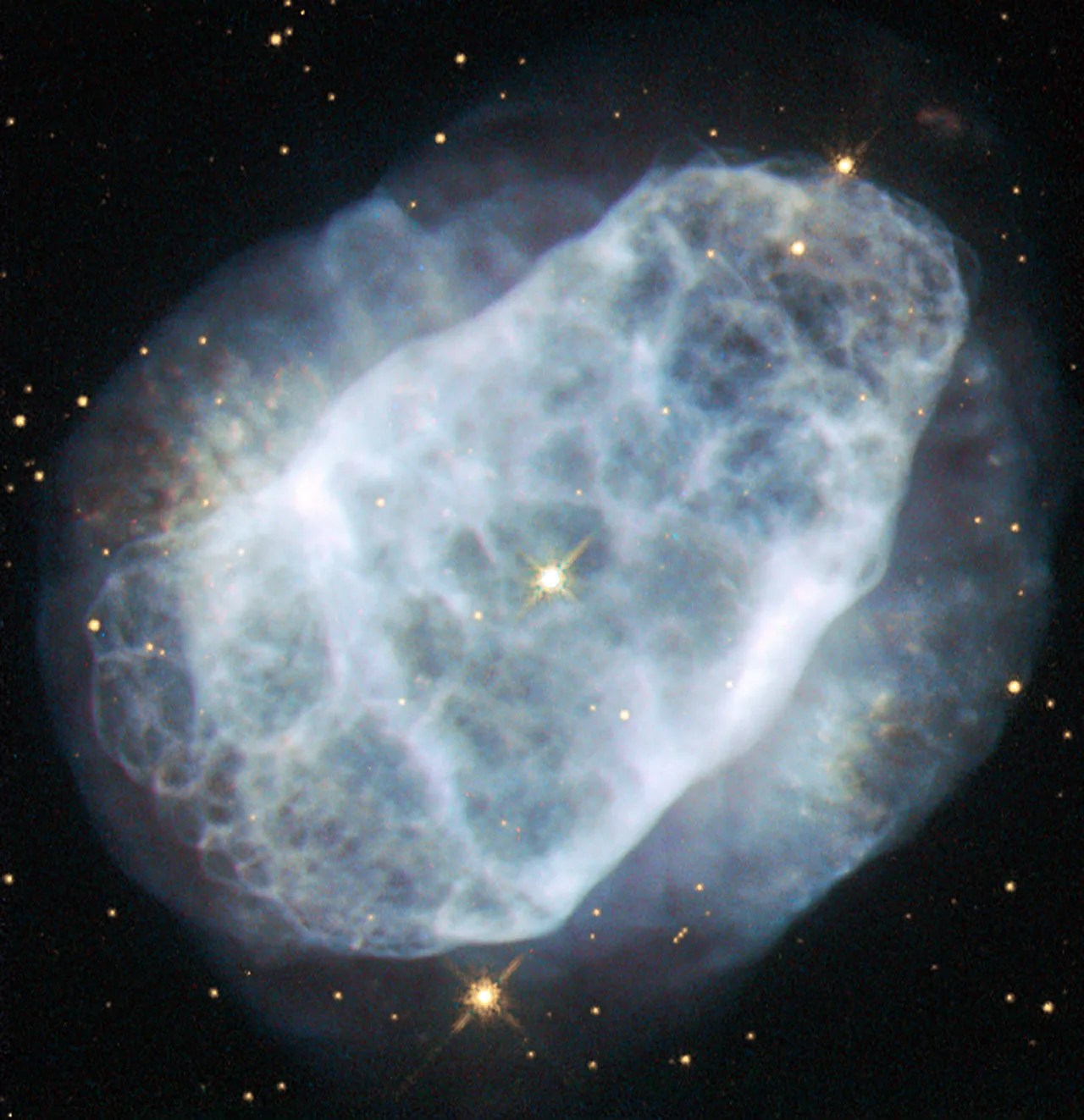 A bluish cloudlike nebula on a black background