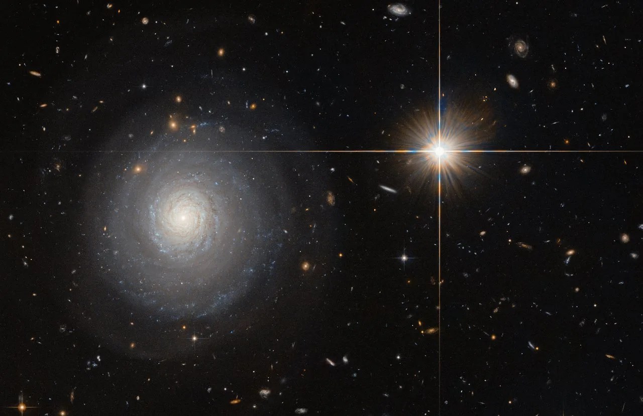 A starburst galaxy on the left and a star in our own galaxy on the right