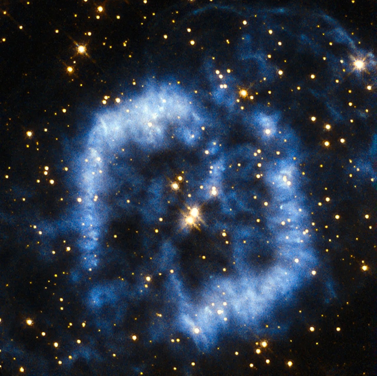 A winding blue cloud forming two lobes around two stars at the center.