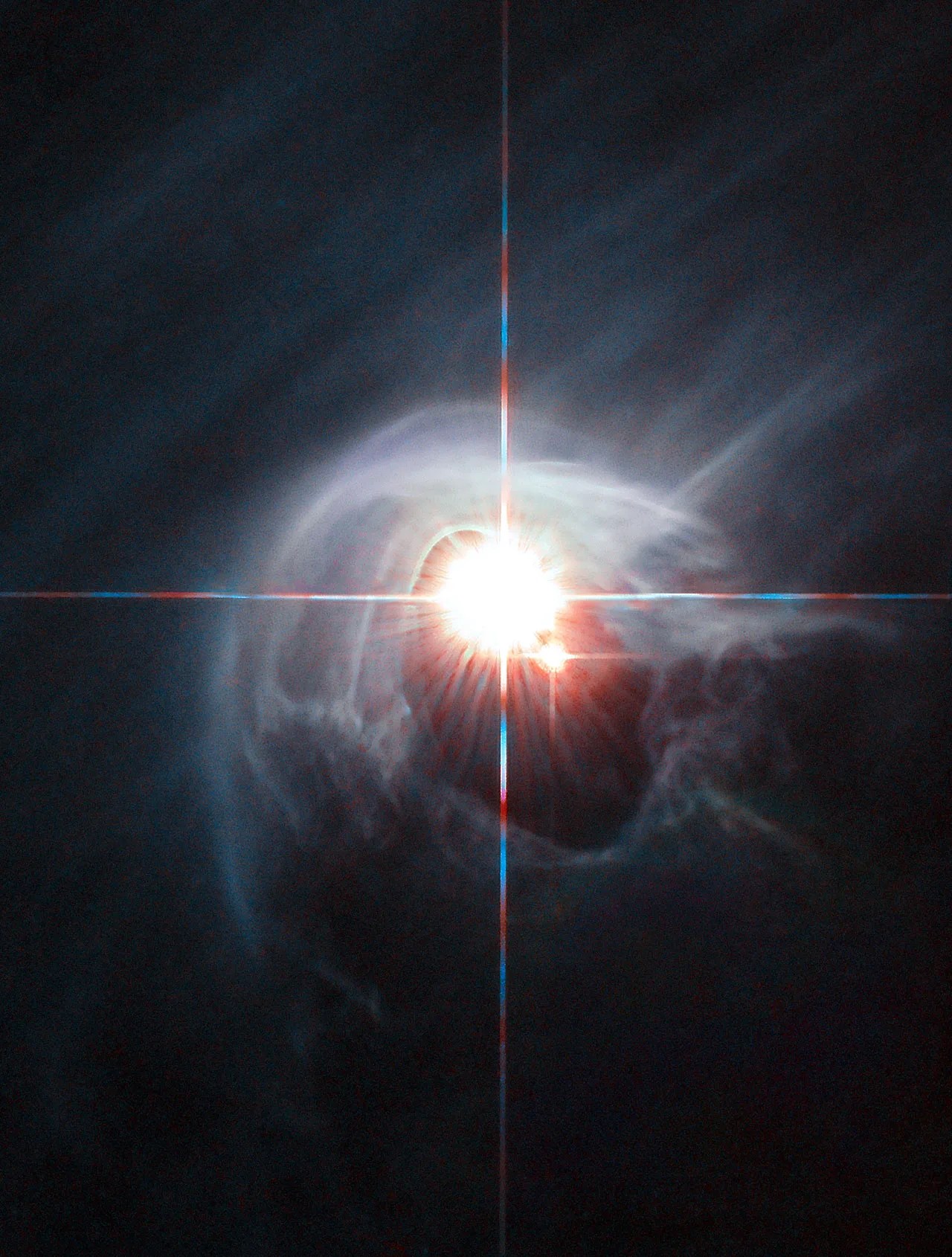 Two stars shine through the center of a ring of cascading dust