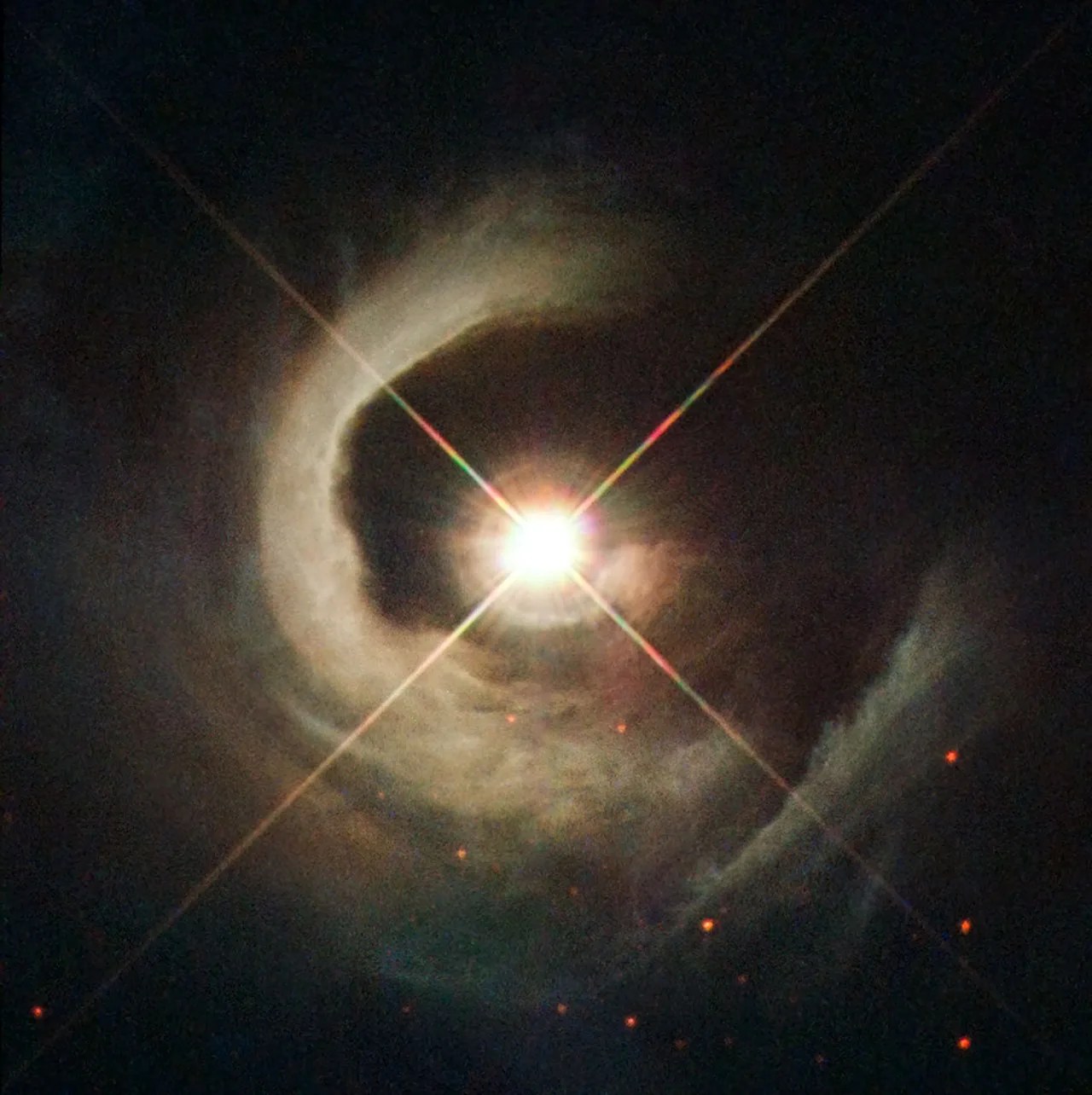 A star with a spiral of dust bordering it