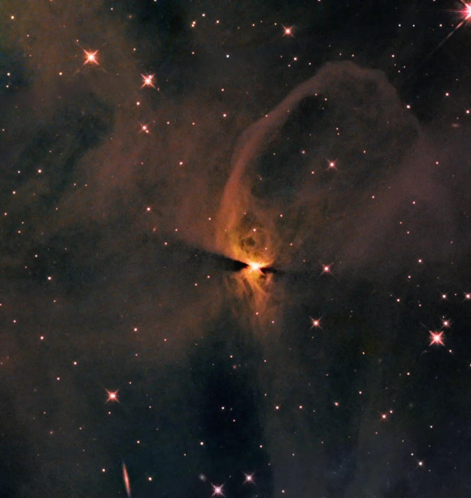 Against a backdrop of stars and distant galaxies, an orange glow of looping clouds emanates from a bright-white central star. dark dust lanes extend from the right and left of the central star.