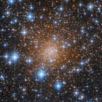 Dense cluster of orange-white stars at center. bright blue-white stars cover the field of view.