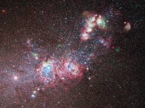 bright white and pink clouds and blue-white stars bisect the image from lower left to upper right