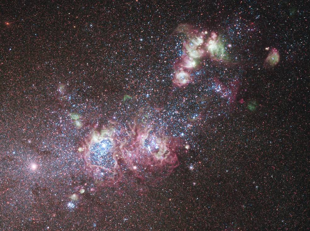 bright white and pink clouds and blue-white stars bisect the image from lower left to upper right