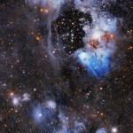 Upper 2/3 holds a bright white and blue gas and dust-cloud ring around a central void or bubble. lower 1/3 holds blue and white