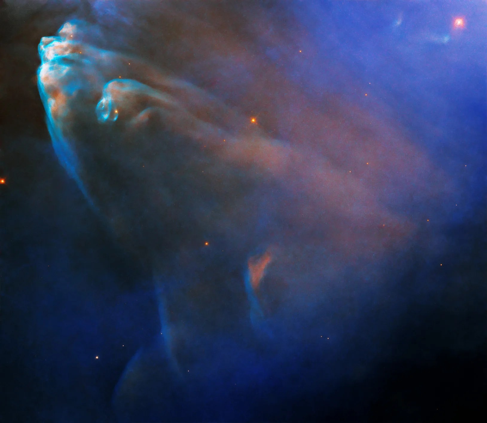 Hubble image of elongated rusty and blue nebula