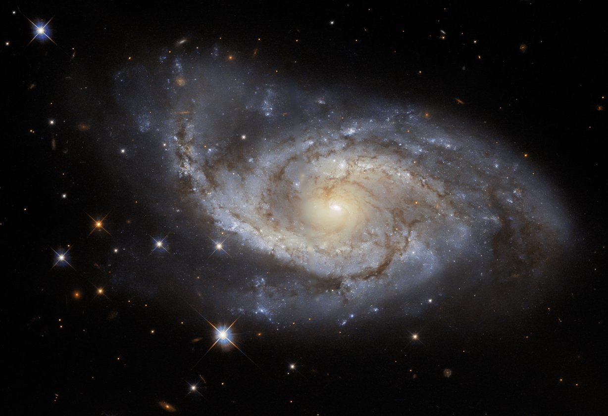 Face on spiral galaxy at center. a spiral of bright star-forming regions and dark dust lanes