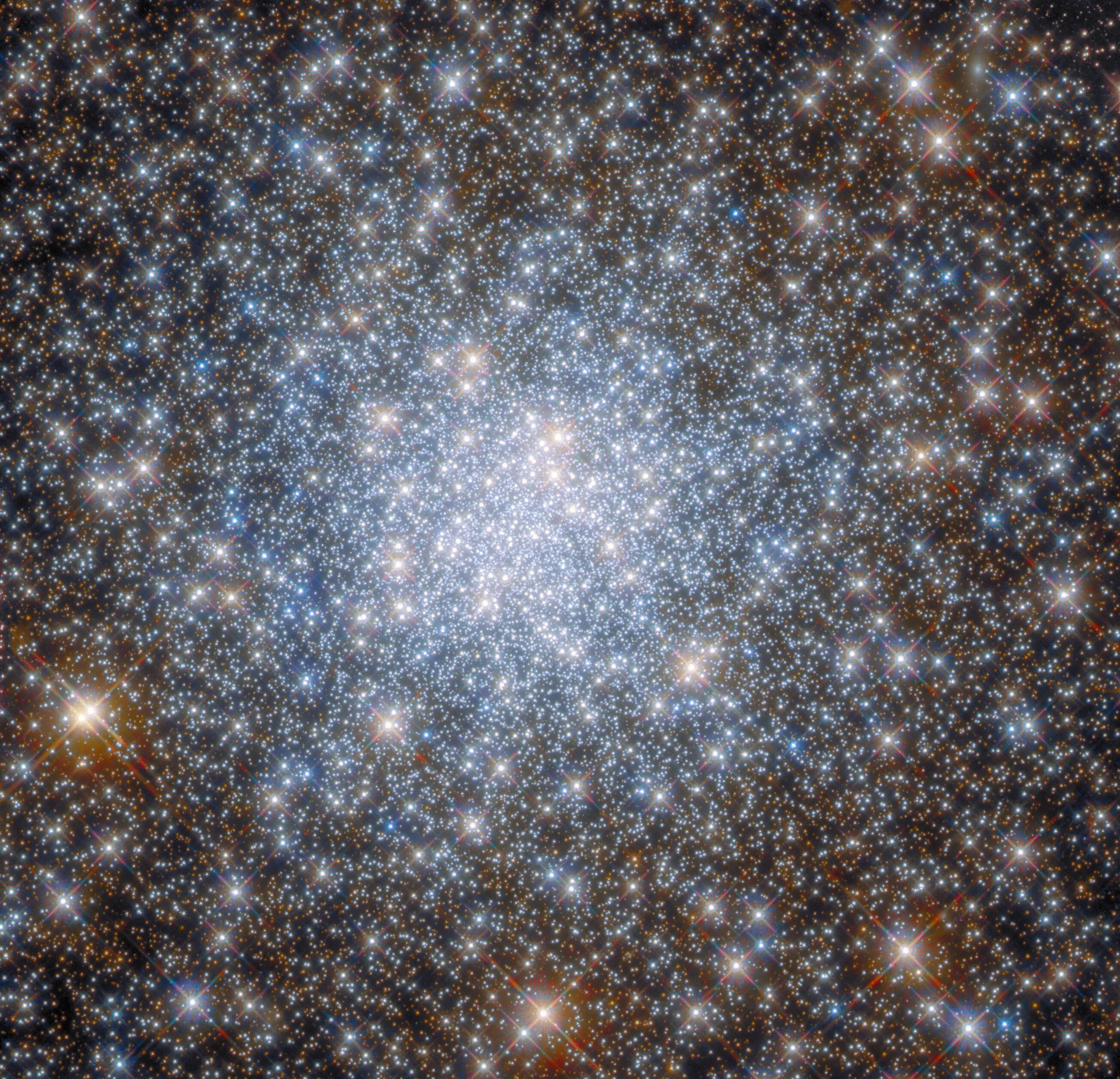 A mass of bright blue-white stars fills the center, gold stars are dotted throughout