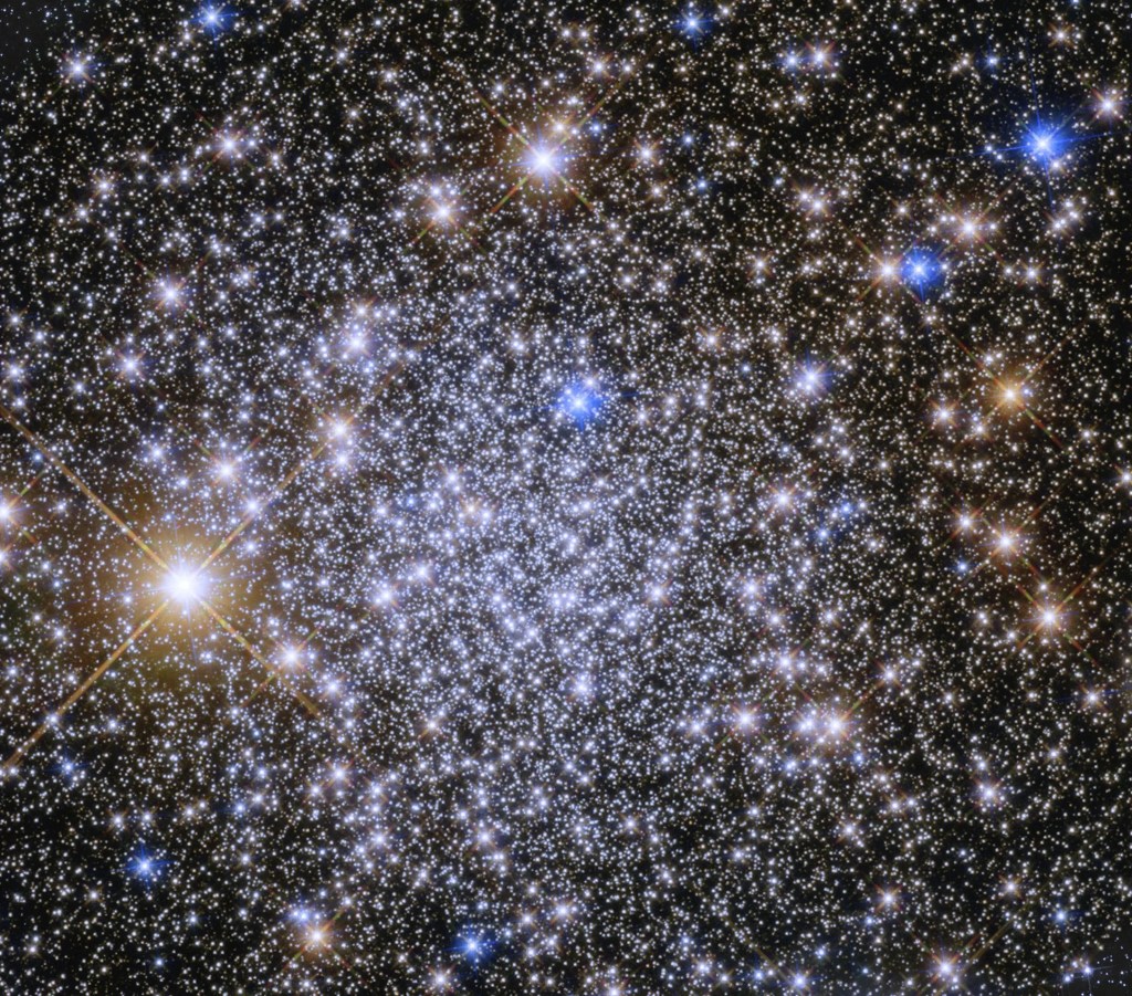 Bright blue-white stars fill the scene with a smattering or bright yellow-white stars