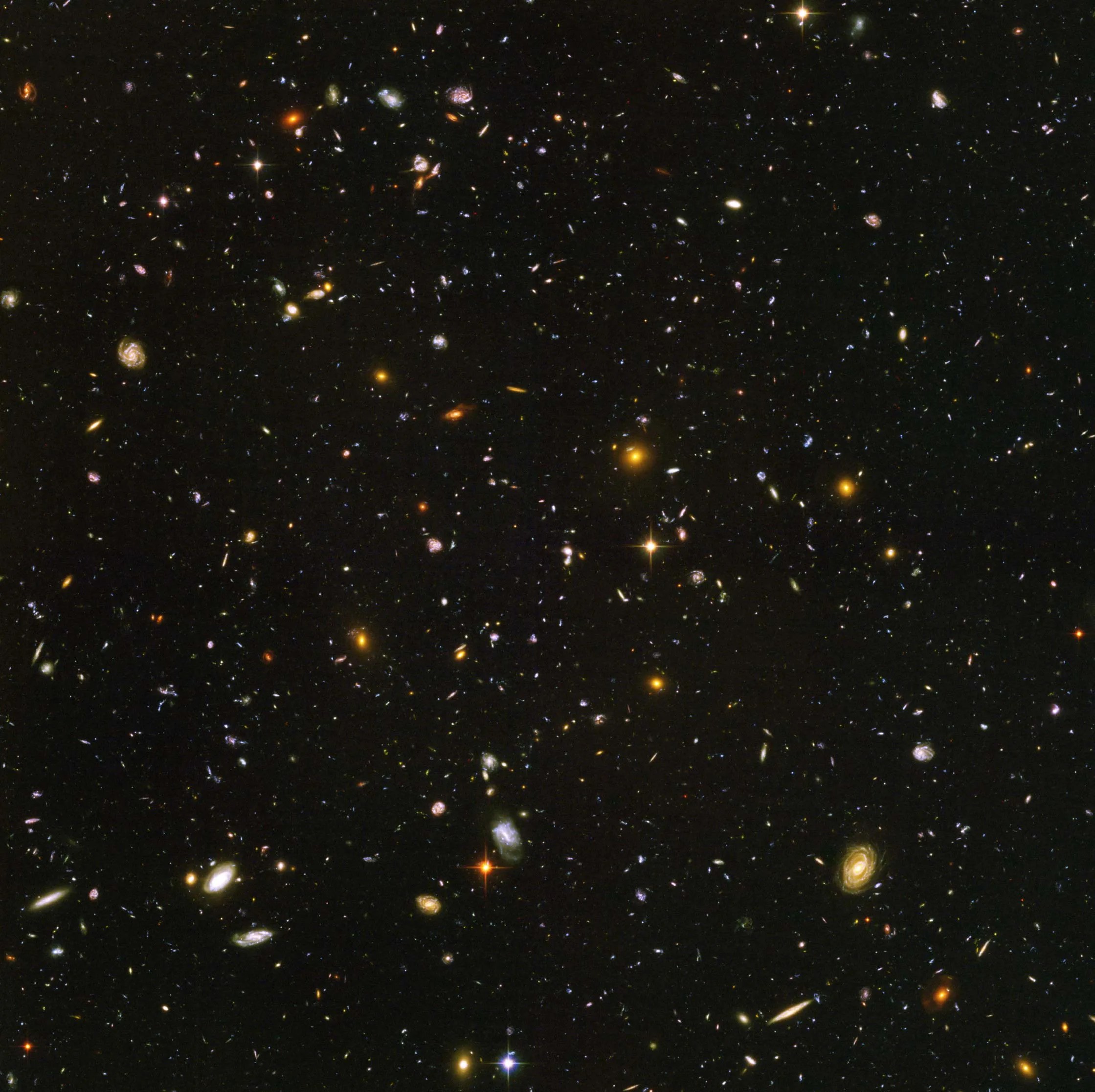 The field of view is filled with galaxies in all shapes, sizes, colors, and galaxy types. All against a black backdrop.