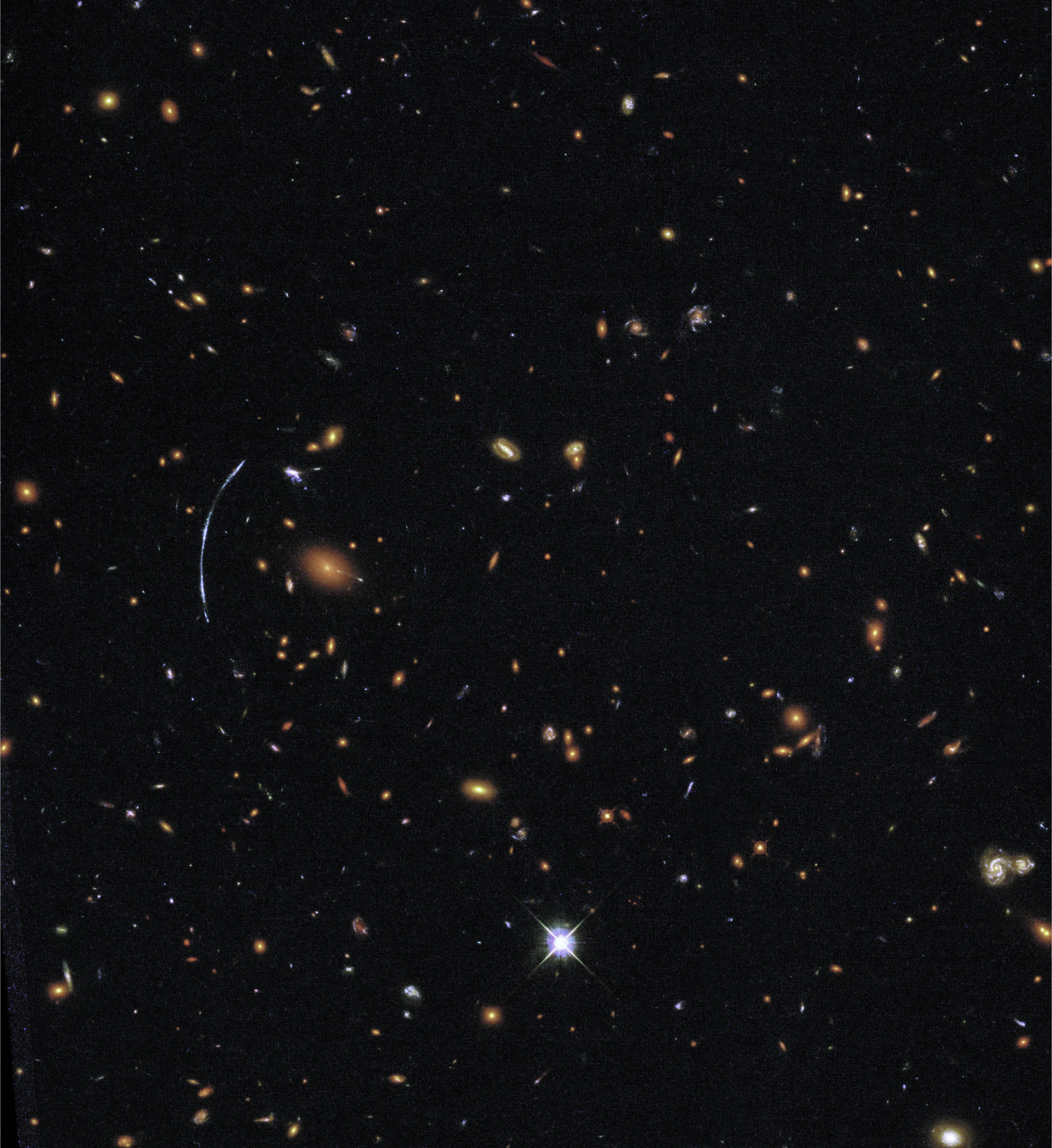 hubble image showing a lensed galaxy among many